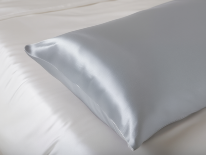 Light grey satin pillow on a white background